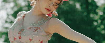 A Woman Wearing A Pink Dress And A Pink Flower Crown GIF