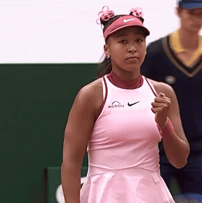 A Woman Wearing A Pink Dress And A Pink Nike Visor GIF
