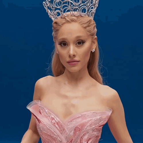 A Woman Wearing A Pink Dress And A Tiara GIF