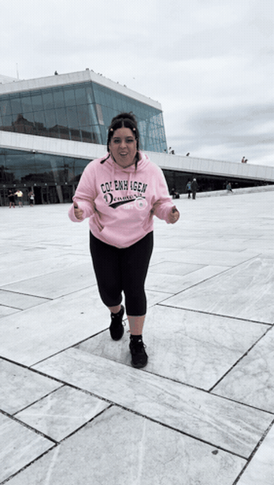 A Woman Wearing A Pink Hoodie That Says Cole Emmy Igen On It GIF