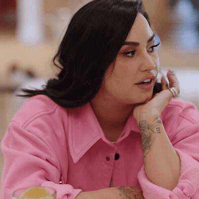 A Woman Wearing A Pink Jacket Has A Tattoo On Her Wrist That Says " I Love You " GIF