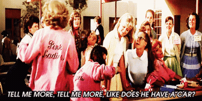 A Woman Wearing A Pink Jacket That Says Pink Ladies Stands In Front Of A Group Of Women GIF