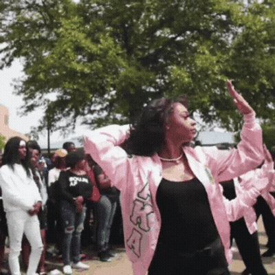 A Woman Wearing A Pink Jacket With The Letters Ka On It GIF