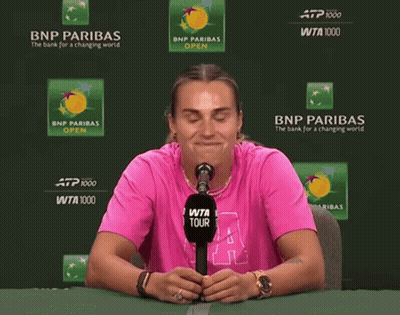 a woman wearing a pink shirt with the letter a on it