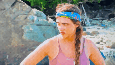 A Woman Wearing A Pink Tank Top And A Blue Headband GIF