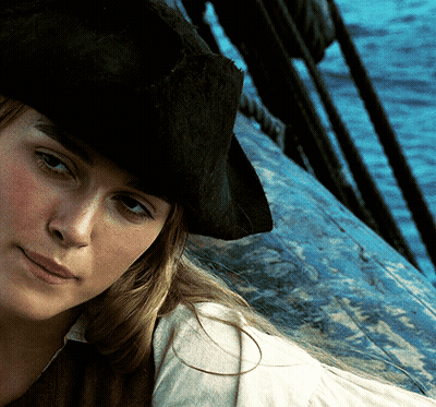 A Woman Wearing A Pirate Hat Is Looking At The Camera GIF