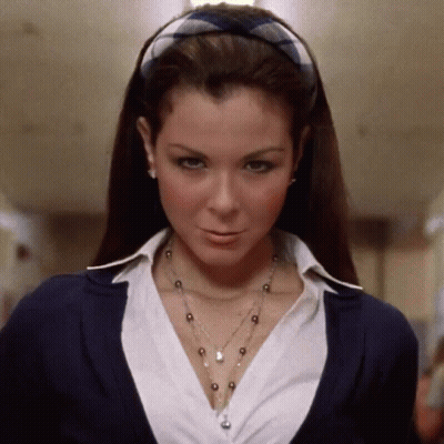 A Woman Wearing A Plaid Headband And A Necklace GIF