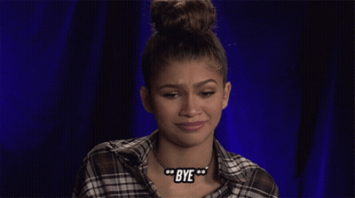 A Woman Wearing A Plaid Shirt And A Bye Necklace GIF