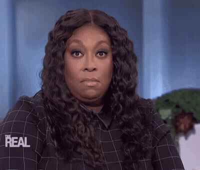A Woman Wearing A Plaid Shirt That Says Real On The Sleeve GIF