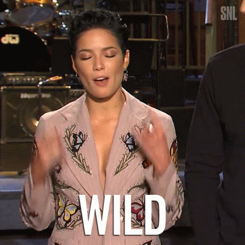 A Woman Wearing A Plunging Jacket With The Word Wild Written On It GIF