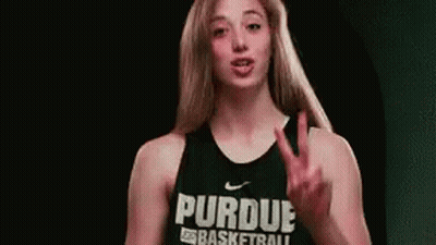 A Woman Wearing A Purdue Basketball Jersey Is Giving The Middle Finger . GIF