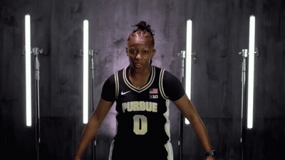 A Woman Wearing A Purdue Jersey With The Number 0 On It GIF