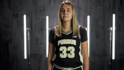 A Woman Wearing A Purdue Jersey With The Number 33 GIF