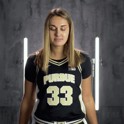 A Woman Wearing A Purdue Jersey With The Number 33 GIF