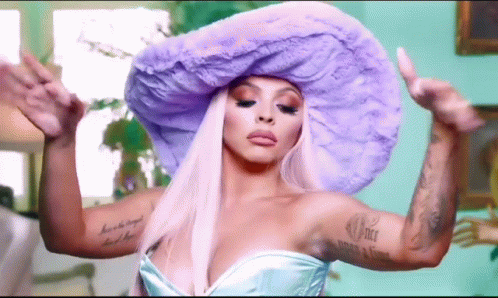 A Woman Wearing A Purple Hat And A Blue Dress . GIF