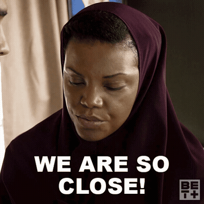 A Woman Wearing A Purple Head Scarf Says We Are So Close GIF