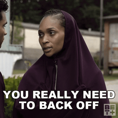 A Woman Wearing A Purple Hijab Says You Really Need To Back Off GIF