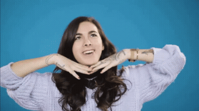 A Woman Wearing A Purple Sweater Has A Tattoo On Her Wrist That Says ' I Love You ' GIF