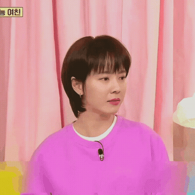 A Woman Wearing A Purple Sweater With A Microphone On Her Neck GIF