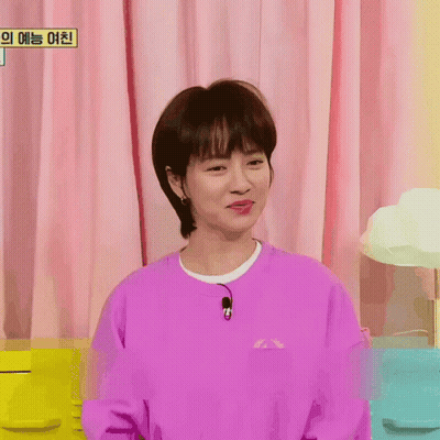 A Woman Wearing A Purple Sweatshirt With A Microphone On Her Neck GIF