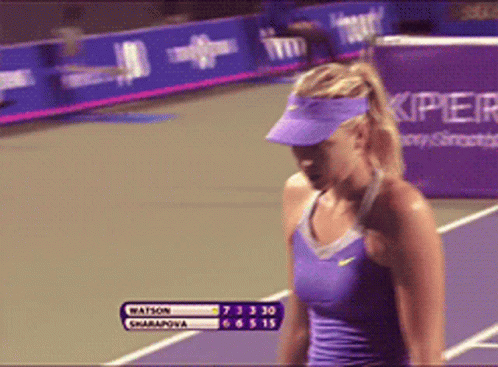 A Woman Wearing A Purple Tank Top And A Visor Stands On A Tennis Court In Front Of A Banner That Says Kiper GIF