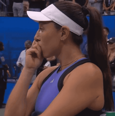 A Woman Wearing A Purple Tank Top And A White Visor Is Covering Her Mouth GIF