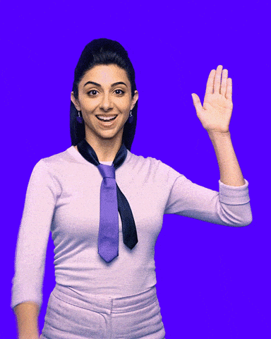 A Woman Wearing A Purple Tie And A White Shirt Waves Her Hand GIF