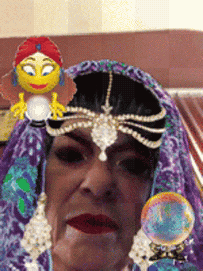 A Woman Wearing A Purple Veil With A Smiley Face On Her Head GIF