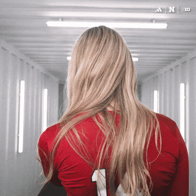 A Woman Wearing A Red Adidas Jersey With The Number 1 On It GIF