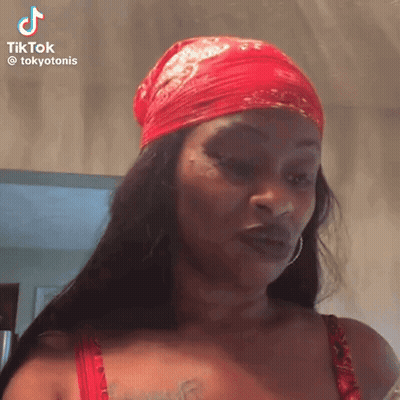 A Woman Wearing A Red Bandana And Red Bra Is Making A Funny Face . GIF