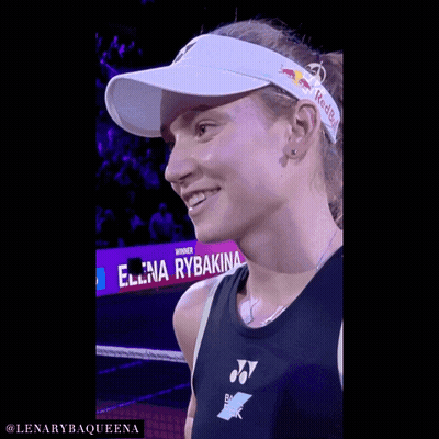 A Woman Wearing A Red Bull Headband Is Smiling GIF