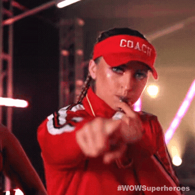 A Woman Wearing A Red Coach Hat Is Pointing Her Finger GIF