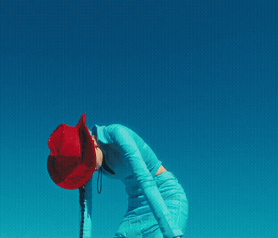 A Woman Wearing A Red Cowboy Hat And A Blue Dress GIF