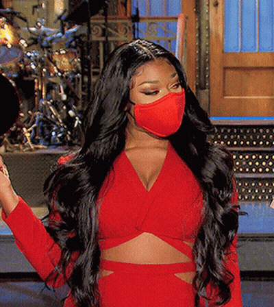 A Woman Wearing A Red Crop Top And A Red Face Mask GIF