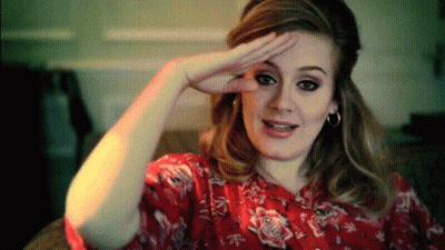 A Woman Wearing A Red Floral Shirt Is Making A Funny Face GIF