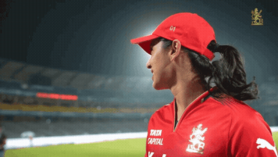 A Woman Wearing A Red Hat And A Red Shirt That Says Tata Capital GIF