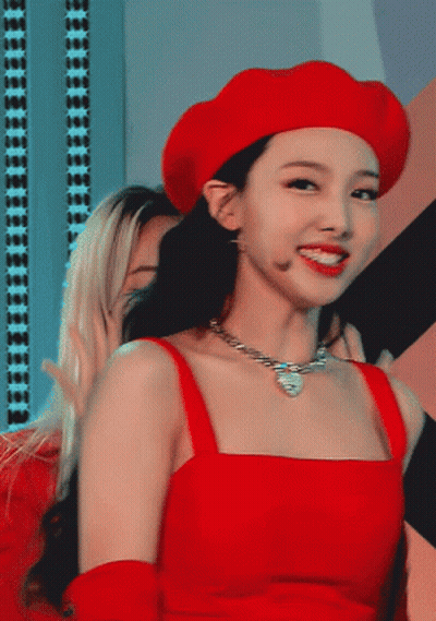 A Woman Wearing A Red Hat And A Red Top GIF
