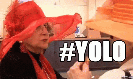A Woman Wearing A Red Hat And A Yellow Hat Says # Yolo GIF