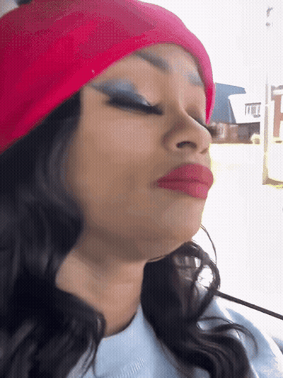 A Woman Wearing A Red Hat And Red Lipstick Is Making A Face GIF