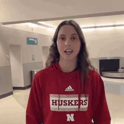 A Woman Wearing A Red Hoodie With The Word Huskers On It GIF