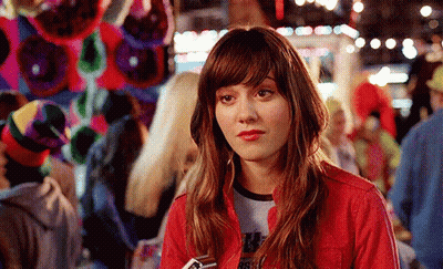 A Woman Wearing A Red Jacket And A T-Shirt That Says ' Rsfw ' On It GIF
