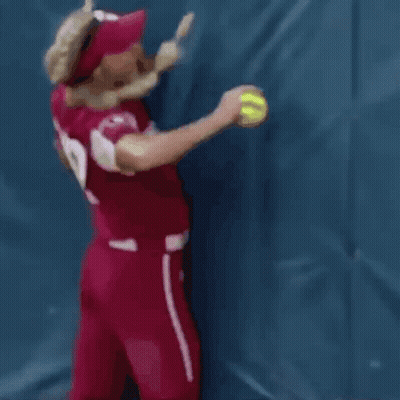 A Woman Wearing A Red Jersey With The Number 12 On It GIF