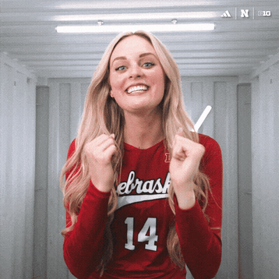 A Woman Wearing A Red Jersey With The Number 14 GIF