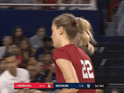 A Woman Wearing A Red Jersey With The Number 22 On The Back GIF