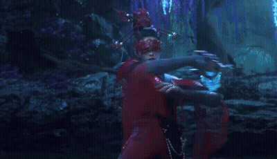 A Woman Wearing A Red Mask Is Holding A Sword GIF