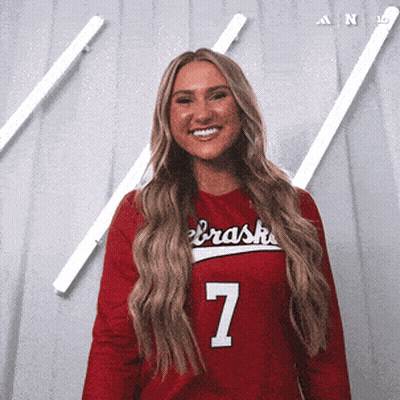A Woman Wearing A Red Nebraska Jersey Number 7 GIF