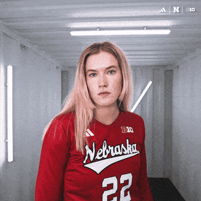 A Woman Wearing A Red Nebraska Jersey With The Number 22 GIF