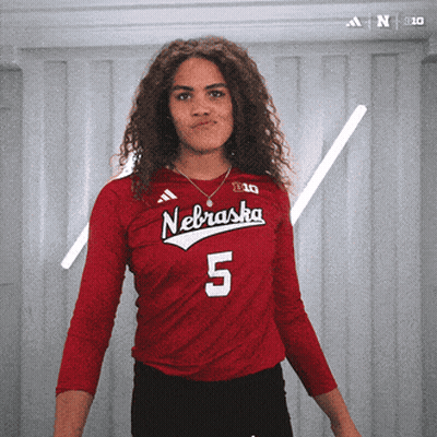 A Woman Wearing A Red Nebraska Jersey With The Number 5 GIF