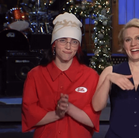 A Woman Wearing A Red Shirt That Says Billie GIF