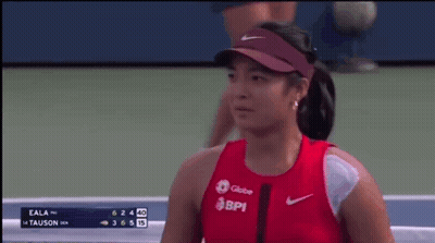 A Woman Wearing A Red Shirt That Says Bpi Is Smiling On A Tennis Court GIF